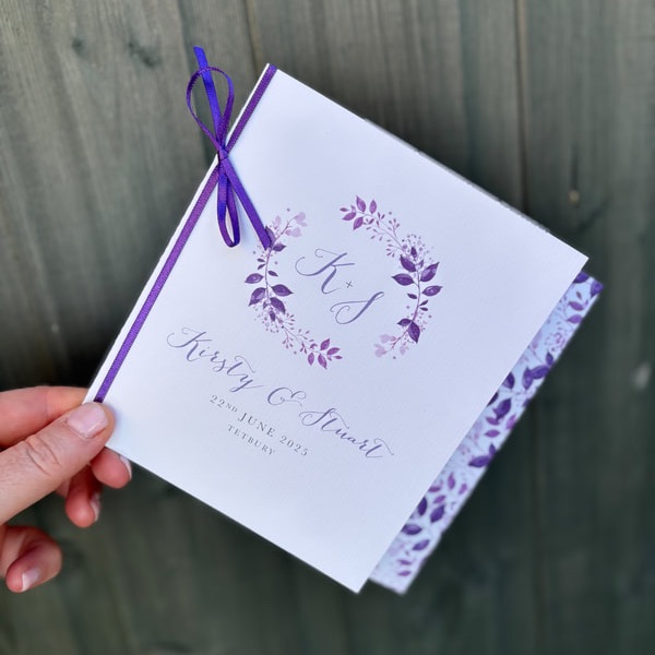 purple wedding invitations, rustic charm invites, handprinted leaves stationery, textured card wedding invites, autumn wedding invites, bespoke wedding bundles, personalised place cards, purple-themed wedding decor, rustic table numbers, elegant autumn wedding designs, UK personalised wedding stationery